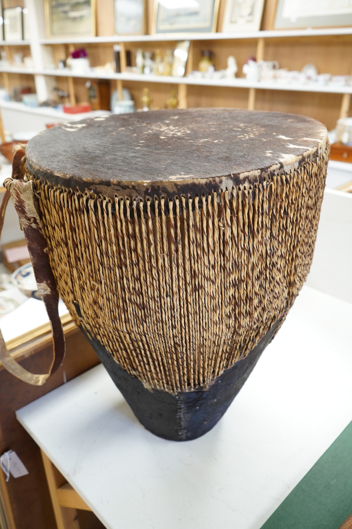 An African drum with a hide skin and gut stretchers, the body of the drum also covered with hide, diameter of the drum 46cm, the height 60cm
